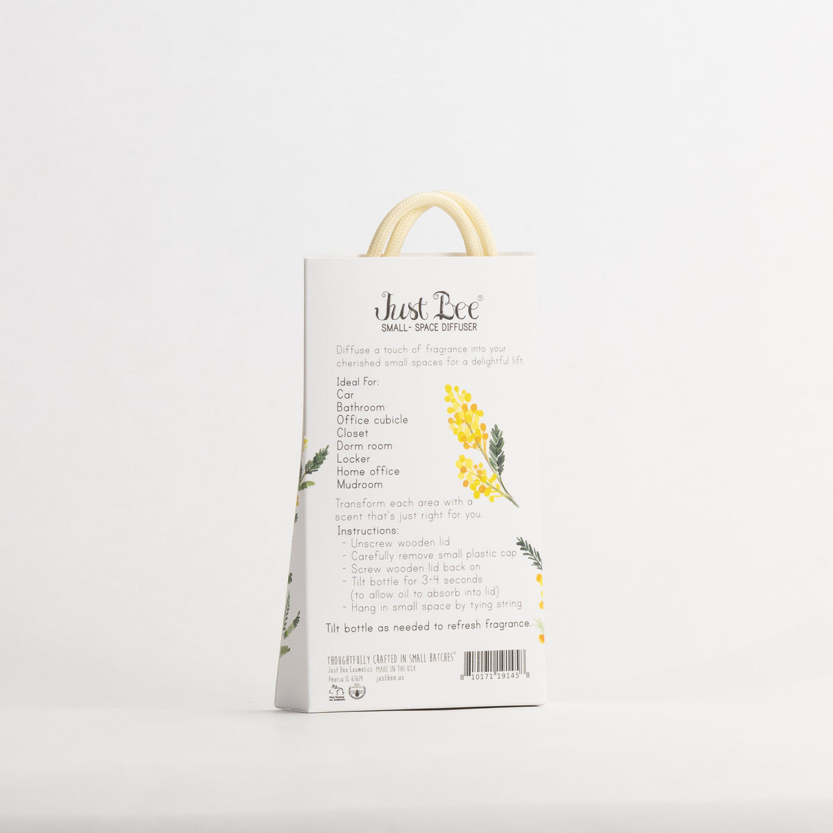 Just Bee Mimosa Small-Space Hanging Diffuser, angled back of the pack with a yellow mimosa sprig and usage details.
