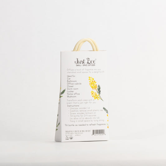 Just Bee Mimosa Small-Space Hanging Diffuser, angled back of the pack with a yellow mimosa sprig and usage details.