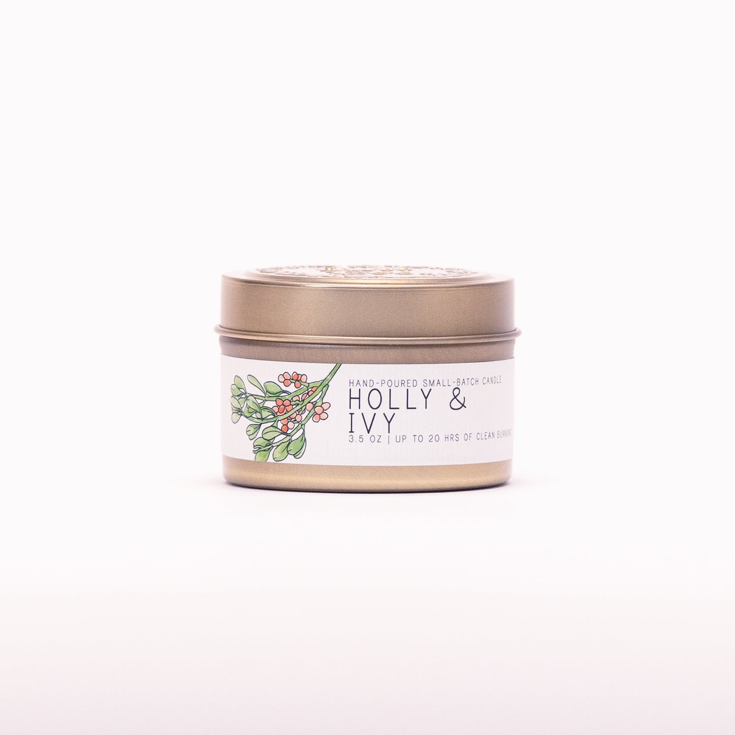Just Bee Holly & Ivy candle in a closed gold travel tin, holly and berry label facing forward.