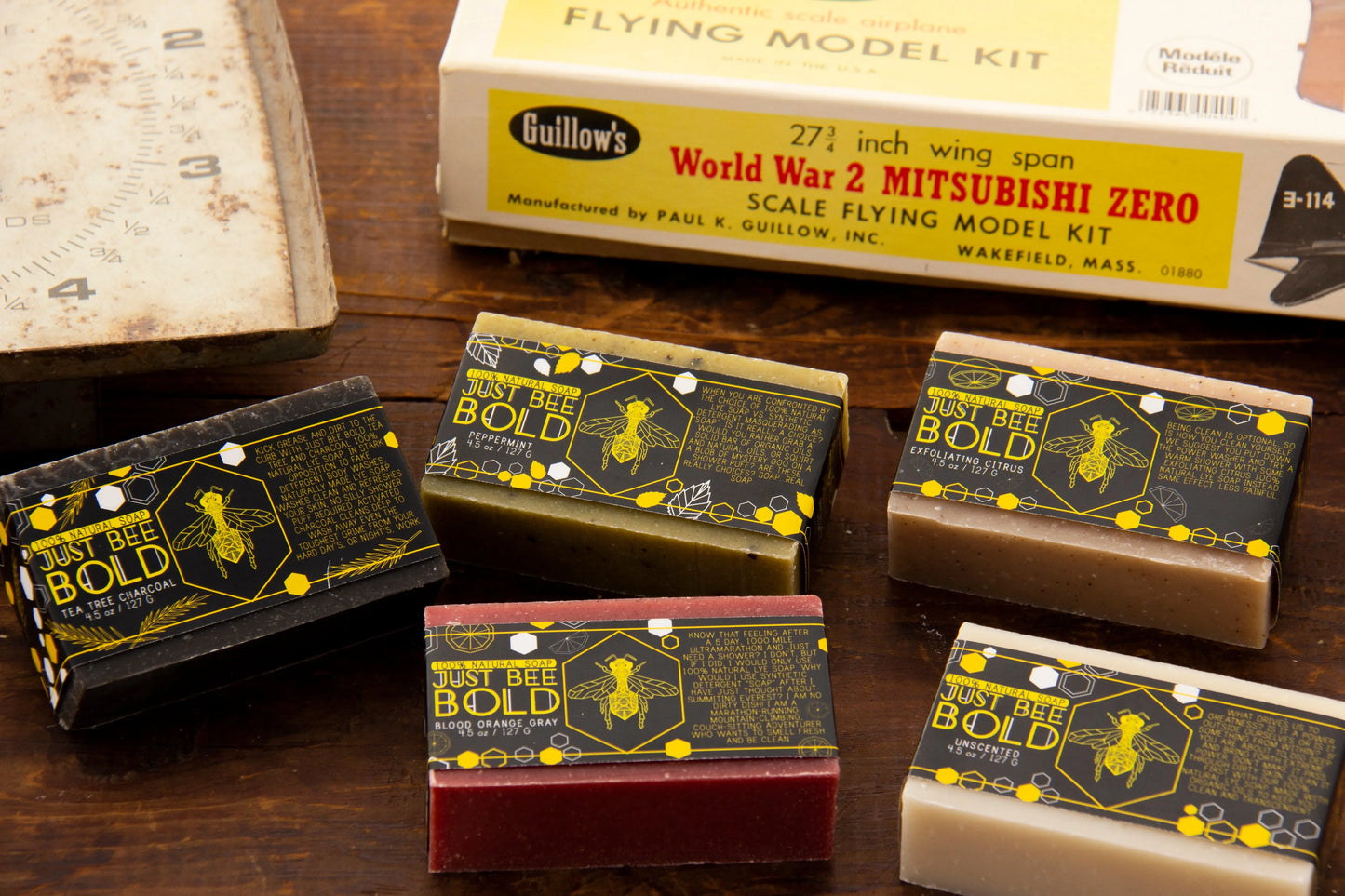 Collection of colorful soap bars arranged next to a vintage model kit box.