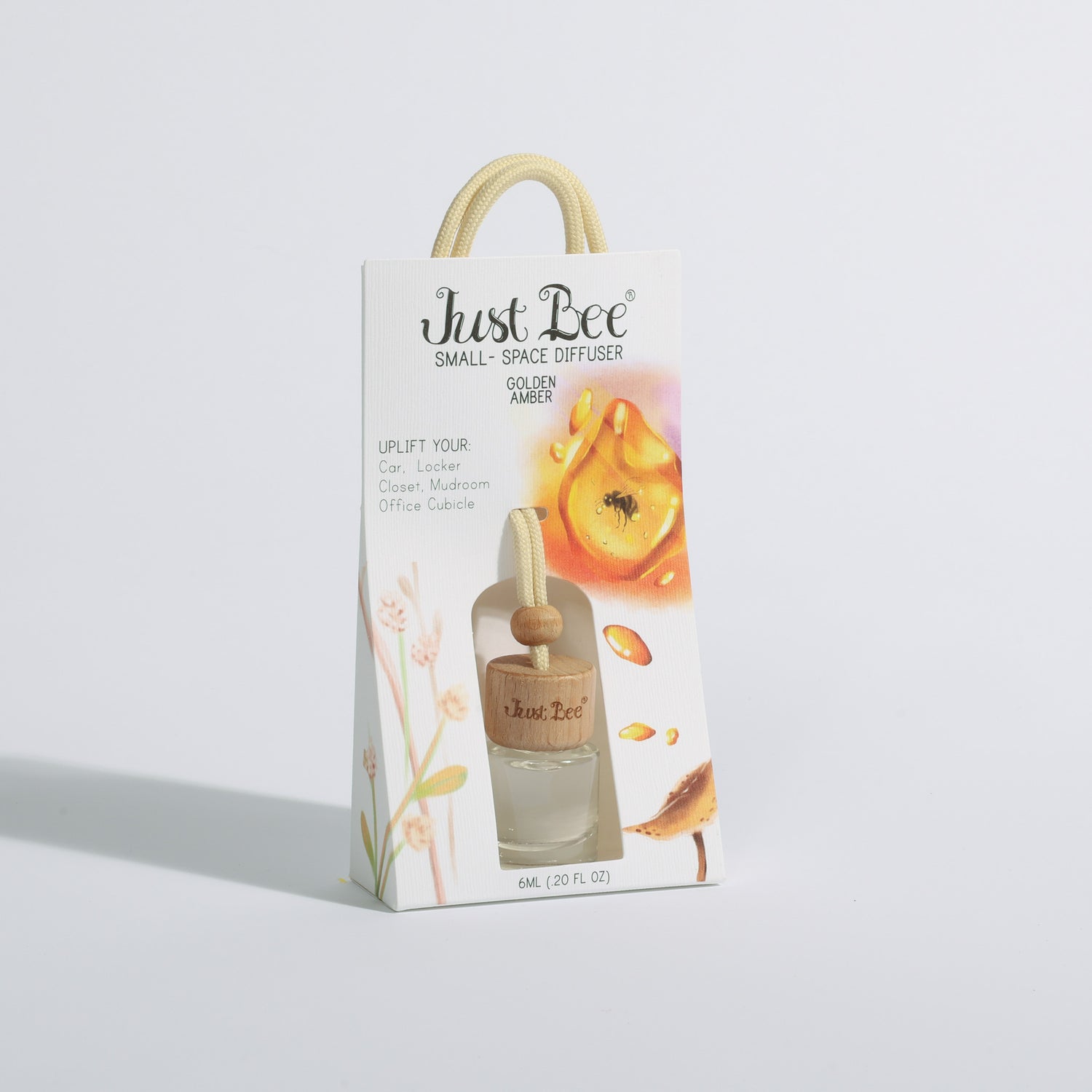 Just Bee Small-Space Hanging Diffuser gift bag labeled Golden Amber with peach illustration packaging, slightly different angle.