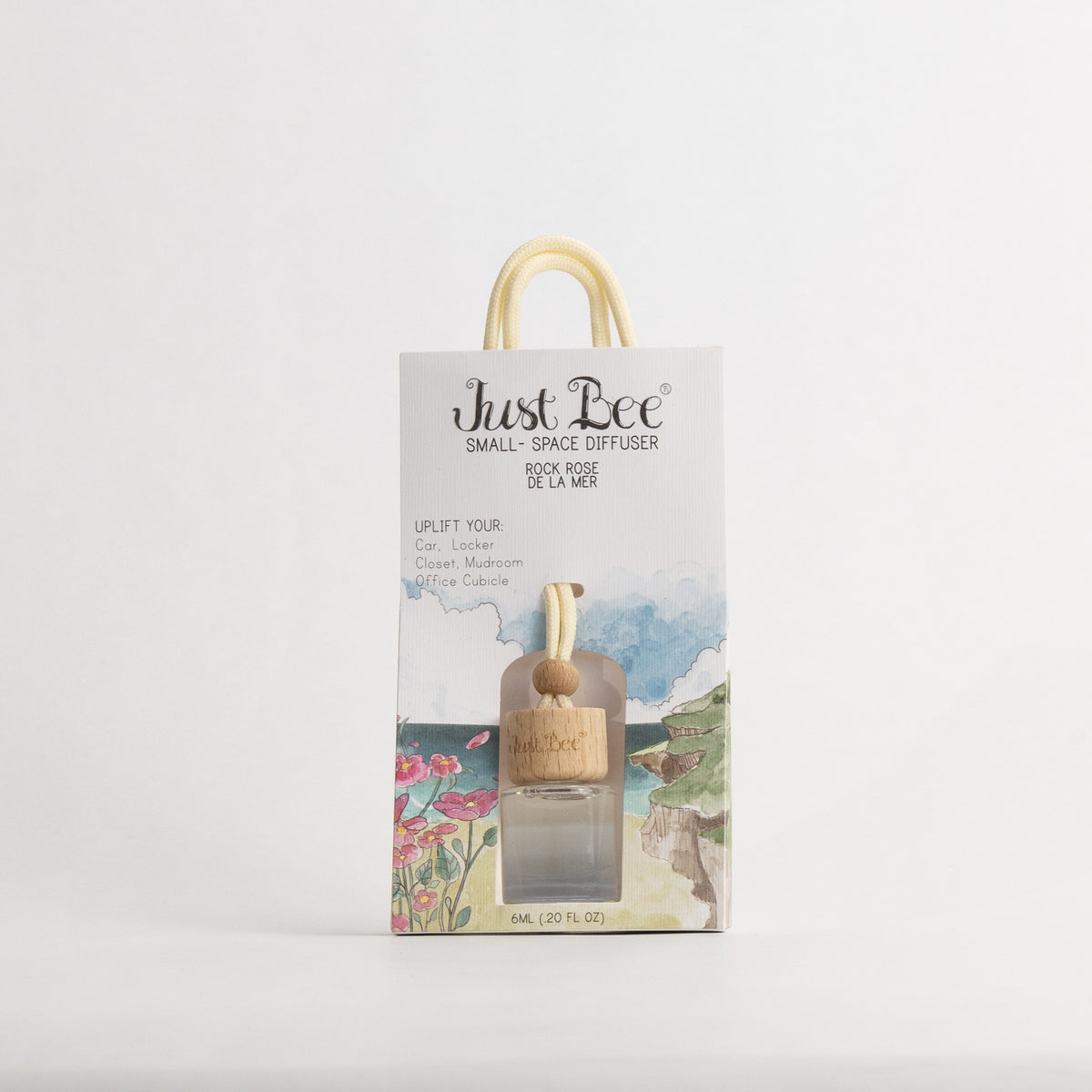 Just Bee Rockrose de la Mer Small-Space Hanging Diffuser, pack front with a painted coastal scene and pink flowers.