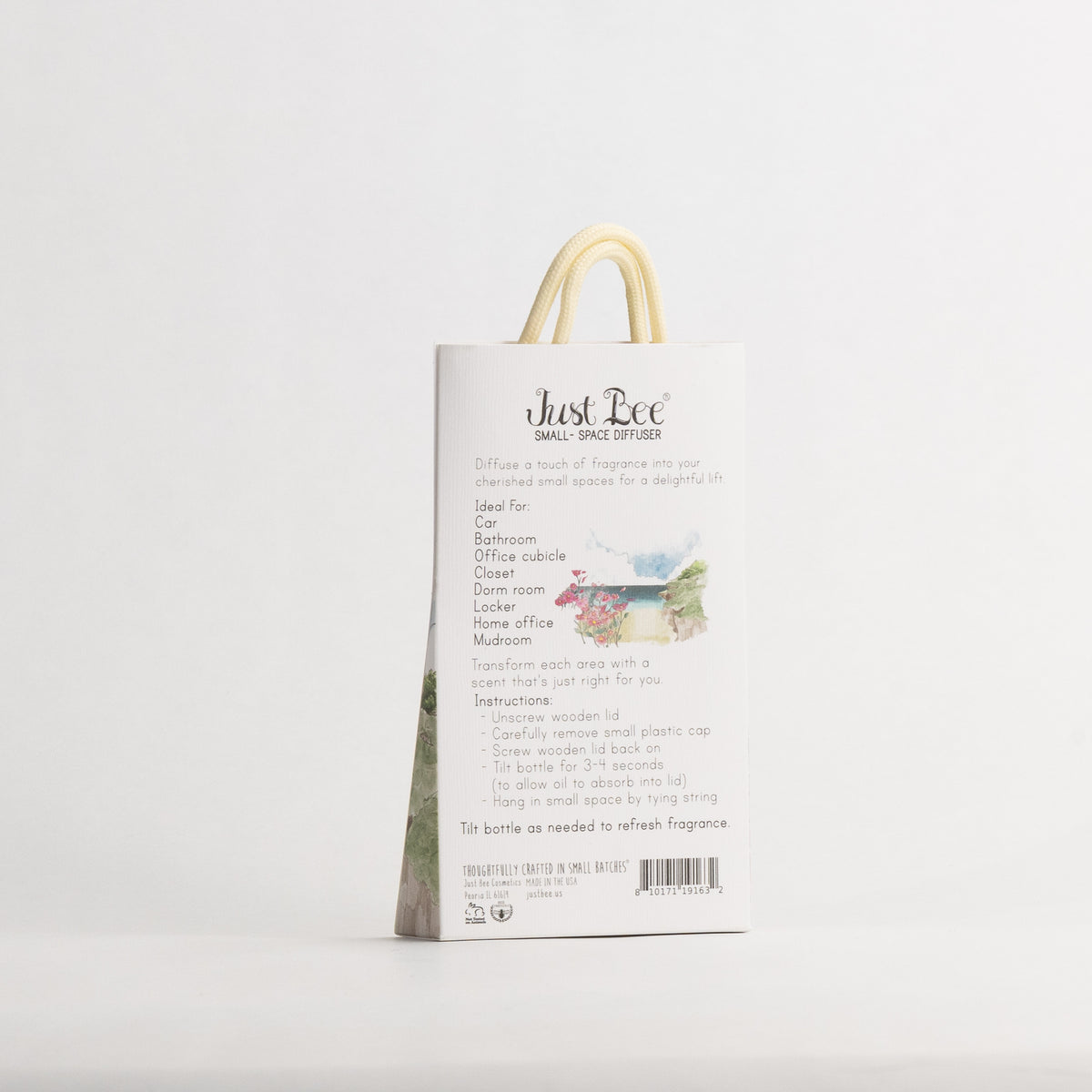 Just Bee Rockrose de la Mer Small-Space Hanging Diffuser, angled back of the pack with a painted coastal scene.