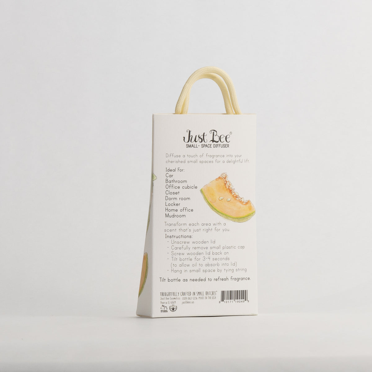 Just Bee Persian Melon & Rosemary Small-Space Hanging Diffuser, angled back of the pack with a cut melon wedge.