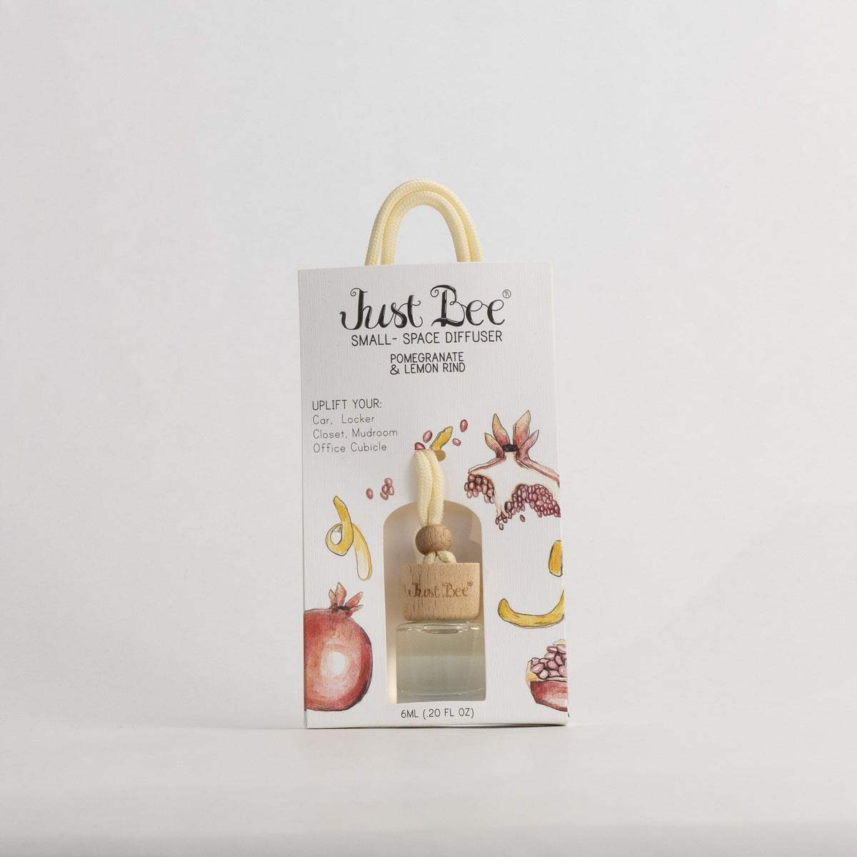 Just Bee Pomegranate & Lemon Rind Small-Space Hanging Diffuser, pack front with a painted pomegranate and lemon peel.