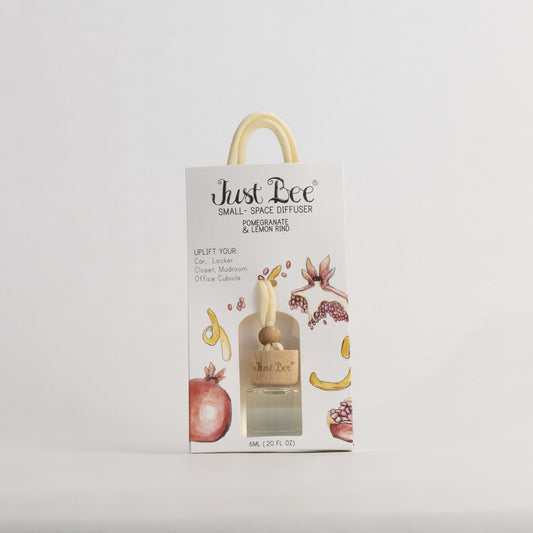 Just Bee Pomegranate & Lemon Rind Small-Space Hanging Diffuser, pack front with a painted pomegranate and lemon peel.