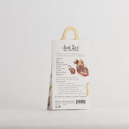 Just Bee Pomegranate & Lemon Rind Small-Space Hanging Diffuser, angled back of the pack with pomegranate and lemon art.