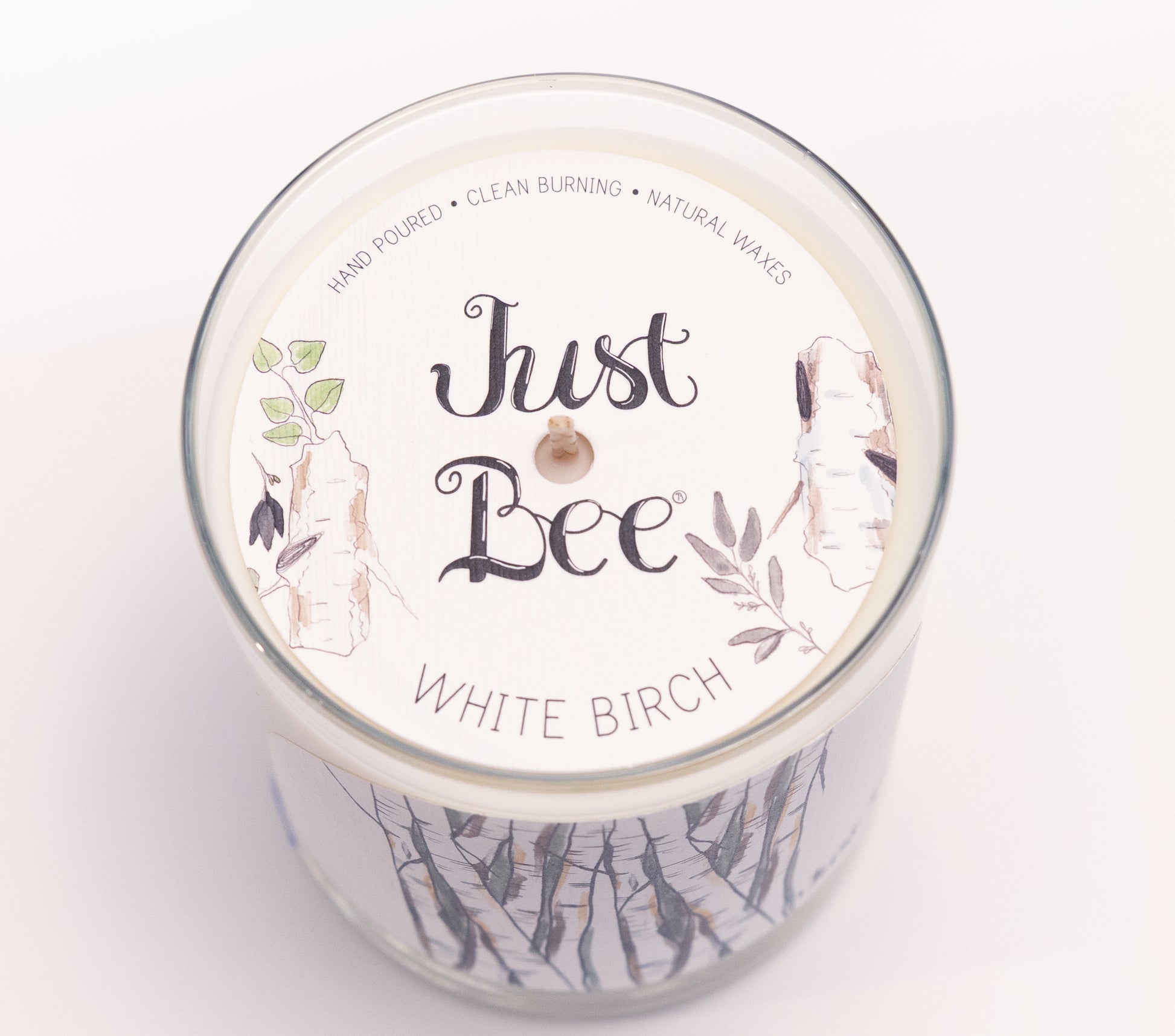 Just Bee White Birch candle seen from above, round lid label with birch branches and a centered wick.
