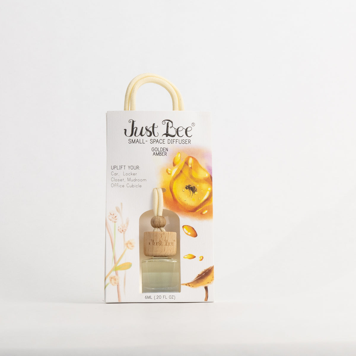 Just Bee Golden Amber Small-Space Hanging Diffuser, pack front painted with a glowing piece of amber resin.