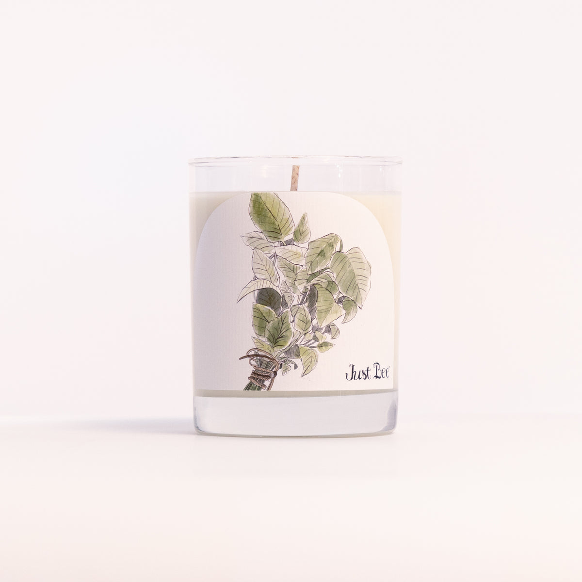 Just Bee Summer Mint candle in a clear glass jar illustrated with fresh green mint sprigs.