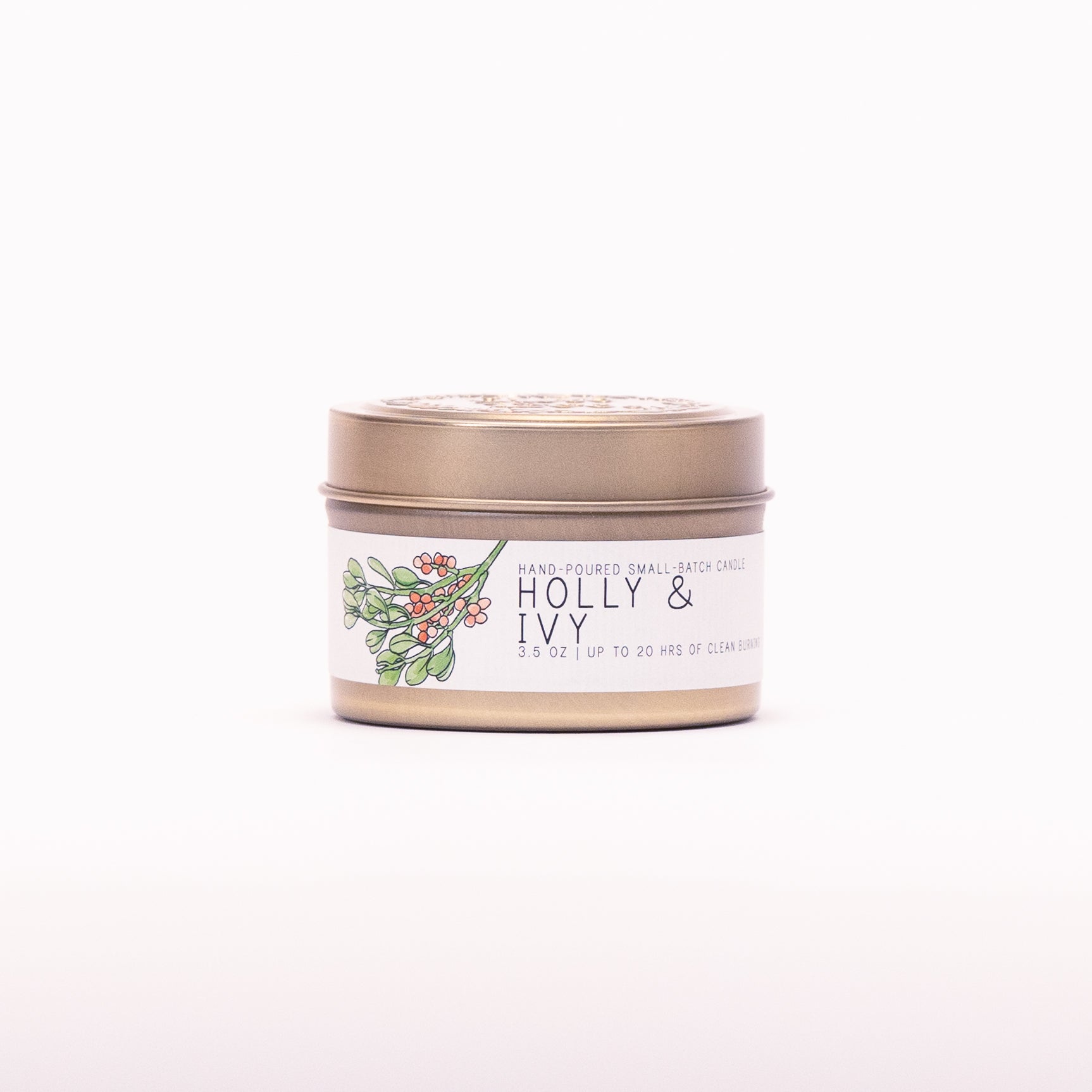 Just Bee Holly & Ivy candle in a closed gold travel tin, holly and berry label facing forward.