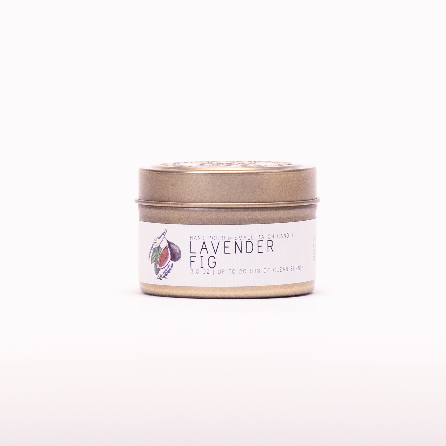 Just Bee Lavender Fig candle in a closed gold travel tin, fig and lavender label facing forward.