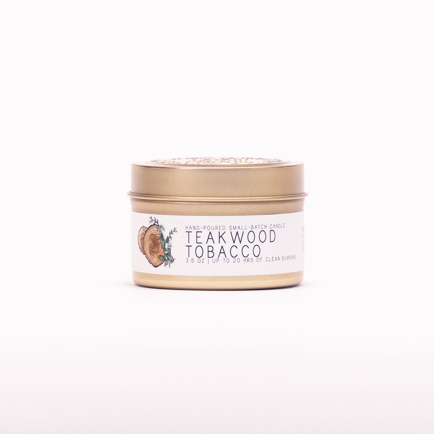 Just Bee Teakwood Tobacco candle in a closed gold travel tin, wood slice label facing forward.